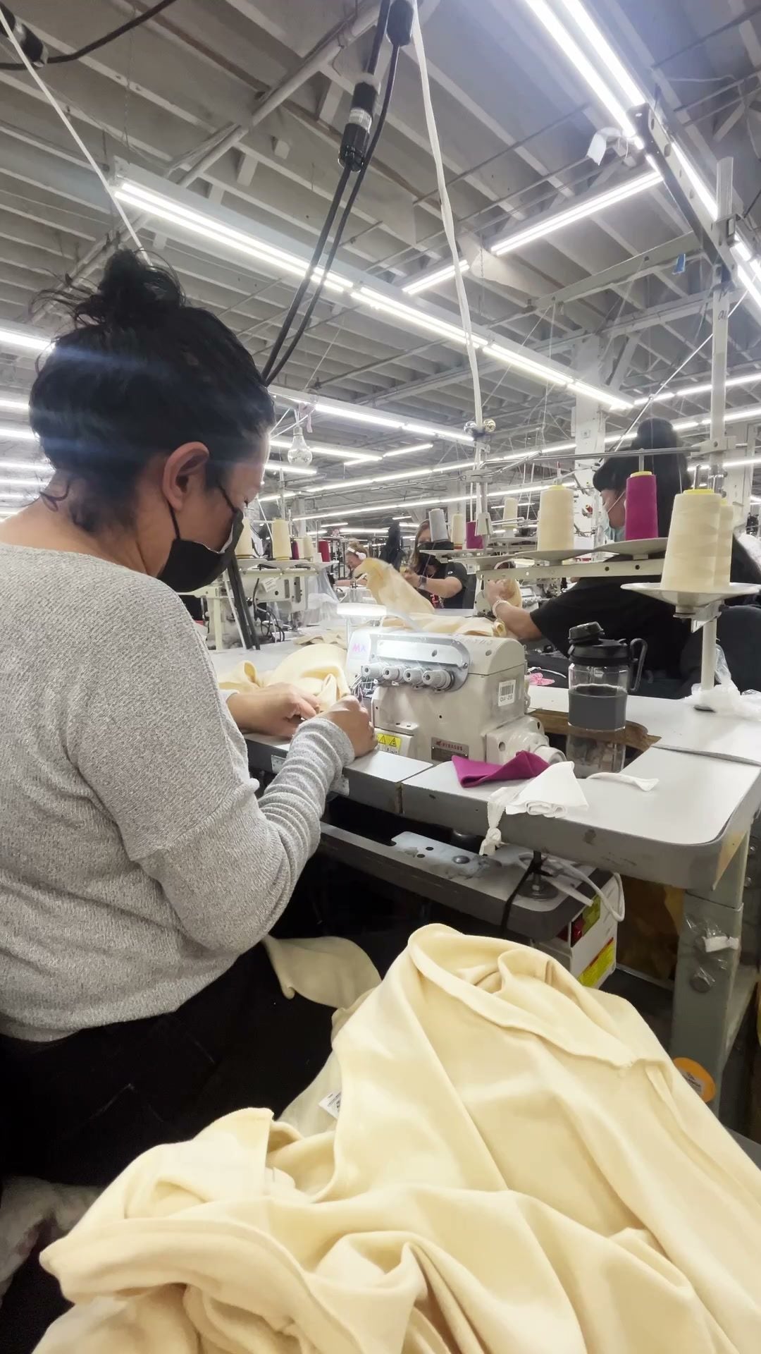 A sewer at her machine on the floor at Los Angeles Apparel